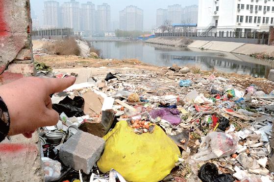 金水河長江路橋下河水發(fā)臭，水邊堆放眾多垃圾