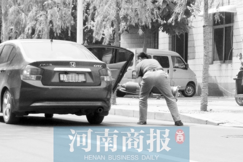 鄭州西區(qū)一氧氣廠門前，有人充氣后，將氧氣瓶裝上私家車運走