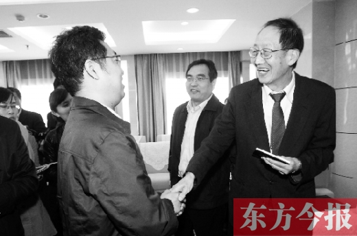 崔琦先生握手東方今報記者靳暉，感謝他把照片珍藏了15年