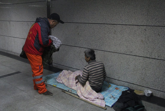 在鄭州一處地下通道，孫德坤挑了幾件衣服送給了流浪者