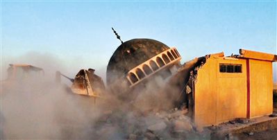 ISIS武裝人員駕駛推土機推倒一座清真寺的墻體。