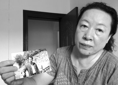 劉吉強的姐姐劉麗霞手持弟弟當年的照片。劉吉強在給家人的書信中多次要求申冤，家人為此奔走了16年。京華