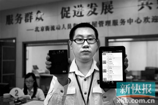 　越秀區(qū)北京街出租屋外來暫住人員管理服務中心的工作人員展示到出租屋登記來穗人員信息的儀器。